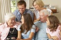 Multi Generation Family Group Sitting On Sofa Indoors Royalty Free Stock Photo