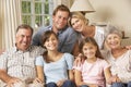 Multi Generation Family Group Sitting On Sofa Indoors Royalty Free Stock Photo