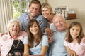 Multi Generation Family Group Sitting On Sofa Indoors Royalty Free Stock Photo