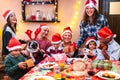 Multi generation family having fun at christmas diner feast - Winter holiday x mas concept with parents and children Royalty Free Stock Photo