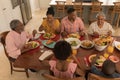 Multi-generation family having meal together on dining table Royalty Free Stock Photo