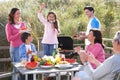 Multi Generation Family Having Outdoor Barbeque