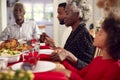 Multi Generation Family Hold Hands Around Table At Home Saying Grace Before Eating Christmas Meal Royalty Free Stock Photo