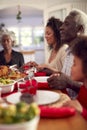 Multi Generation Family Hold Hands Around Table At Home Saying Grace Before Eating Christmas Meal Royalty Free Stock Photo