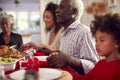 Multi Generation Family Hold Hands Around Table At Home Saying Grace Before Eating Christmas Meal Royalty Free Stock Photo