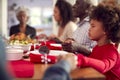 Multi Generation Family Hold Hands Around Table At Home Saying Grace Before Eating Christmas Meal Royalty Free Stock Photo