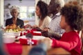 Multi Generation Family Hold Hands Around Table At Home Saying Grace Before Eating Christmas Meal Royalty Free Stock Photo