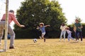 Multi-Generation Family At Home In Garden Playing Football Or Soccer Together Royalty Free Stock Photo