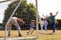 Multi-Generation Family At Home In Garden Playing Football Or Soccer Together Royalty Free Stock Photo