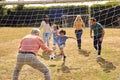 Multi-Generation Family At Home In Garden Playing Football Or Soccer Together Royalty Free Stock Photo