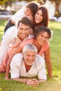 Multi Generation Family Lying In Pile Up On Grass Together Royalty Free Stock Photo