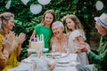 Multi-generation family on outdoor summer garden party, celebrating birthday Royalty Free Stock Photo
