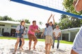 Multi Generation Family Playing Volleyball In Garden Royalty Free Stock Photo