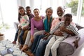 Multi-generation family relaxing together on a sofa in living room at home Royalty Free Stock Photo