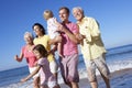 Multi Generation Family Running Along Beach Together Royalty Free Stock Photo