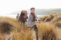 Multi Generation Family In Sand Dunes On Winter Beach Royalty Free Stock Photo