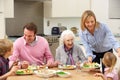 Multi-generation family sharing meal together Royalty Free Stock Photo