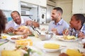 Multi-Generation Family Sitting Around Table Eating Meal Royalty Free Stock Photo