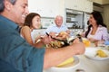 Multi-Generation Family Sitting Around Table Eating Meal Royalty Free Stock Photo