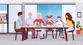 Multi generation family sitting around table eating meal together happy grandparents parents and children modern kitchen Royalty Free Stock Photo