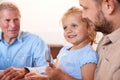 Multi-Generation Family Sitting Around Table Enjoying Meal At Home Together Royalty Free Stock Photo