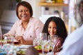 Multi-Generation Family Sitting Around Table At Home Enjoying Meal Together Royalty Free Stock Photo