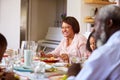 Multi-Generation Family Sitting Around Table At Home Enjoying Meal Together Royalty Free Stock Photo