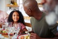 Multi-Generation Family Sitting Around Table At Home Enjoying Meal Together Royalty Free Stock Photo