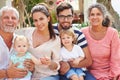 Multi Generation Family Sitting Outdoors At Home Together Royalty Free Stock Photo