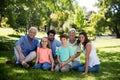 Multi generation family sitting in park Royalty Free Stock Photo