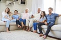 Multi Generation Family Sitting On Sofa At Home Watching TV Royalty Free Stock Photo