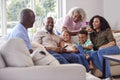 Multi Generation Family Sitting On Sofa In Lounge At Home Talking And Watching TV Royalty Free Stock Photo