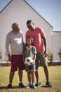 Multi-generation family standing in garden with football Royalty Free Stock Photo