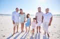 Multi generation family standing together at the beach. Mixed race family with two children, two parents and Royalty Free Stock Photo