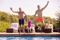 Multi-Generation Family On Summer Holiday Jumping Into Swimming Pool Royalty Free Stock Photo