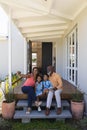 Multi-generation family taking selfie with mobile phone in the porch Royalty Free Stock Photo