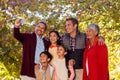 Multi-generation family taking selfie at park Royalty Free Stock Photo