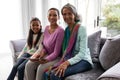 Multi-generation family using digital tablet on a sofa in living room at home Royalty Free Stock Photo