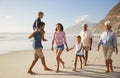 Multi Generation Family On Vacation Walking Along Beach Together Royalty Free Stock Photo