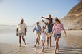 Multi Generation Family On Vacation Walking Along Beach Together Royalty Free Stock Photo