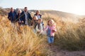 Multi-Generation Family Walking Along Path Through Sand Dunes Together Royalty Free Stock Photo