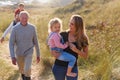 Multi-Generation Family Walking Along Path Through Sand Dunes Together Royalty Free Stock Photo