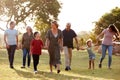 Multi-Generation Family Walking In Countryside Against Flaring Sun Royalty Free Stock Photo