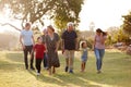 Multi-Generation Family Walking In Countryside Against Flaring Sun Royalty Free Stock Photo