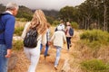 Multi-generation family walking through a forest, back view