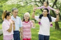 Multi generation family walks together in the park Royalty Free Stock Photo