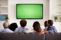 Multi generation family watching TV at home, back view Royalty Free Stock Photo