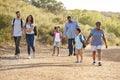 Multi Generation Family Wearing Backpacks Hiking In Countryside Together Royalty Free Stock Photo