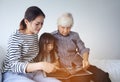 Multi-generation Female members of a family looking at a photo a Royalty Free Stock Photo