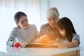 Multi-generation Female members of a family looking at a photo a Royalty Free Stock Photo